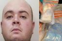 Liam Duffy and the haul of cash and heroin worth almost £250,000 seized by police from a series of raids in Norwich, along with a cash counting machine. The two dark square blocks are heroin with a street value of £100,000 each. Picture: DENISE BRADLEY