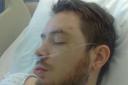 Dan Tidd, pictured recovering in hospital after the attack last year.