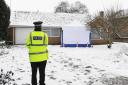 A Police officer stands outside the home of murder victim Una Crown. Picture: Ian Burt