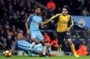 Arsenal's Hector Bellerin (right) gets past Manchester City's Aleksandar Kolarov (left) and Gael Clichy during the Premier League match at the Etihad Stadium, Manchester.