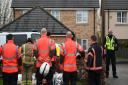 Members of the Cambridgeshire Fire and Rescue Service lay flowers at the scene of a house fire on Buttercup Avenue, Eynesbury, Cambridgeshire, in which a three-year-old boy and a seven-year-old girl died. A 35-year-old woman and a 46-year-old were also in