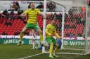 Norwich City duo Ashley Barnes and Borja Sainz celebrate in front of the away end at Stoke