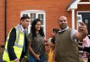Rishi Sunak poses for a picture with Jai John Jose (right) and the Mathew family during a visit to the Taylor Wimpey Heather Gardens housing development in Hethersett