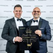 Greg Munford, chief executive of Richardson’s Boating Holidays (right) receives the award from Luke Hansford, senior vice president