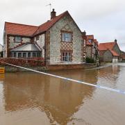 A Norfolk village has been left submerged by flooding