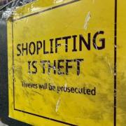 A woman has been banned from stores after admitting shoplifting