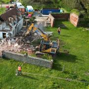 An 18th century farmhouse has been demolished after hanging perilously over a cliff at Trimingham on the north Norfolk coast