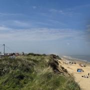 A woman suspected of shooting teenagers for climbing on Hemsby cliffs has said it is a case of mistaken identity.