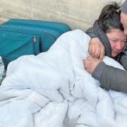 Marie Cattermole (left) being held while living on the streets of Norwich