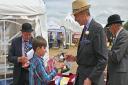 Robert Mumford, nine, receiving his farm innovation trophy from Royal Norfolk Show president the Marquess of Cholmondeley