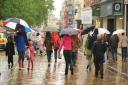 Heavy rain hits Norwich. Shoppers under umbrellas. Picture: Denise Bradley