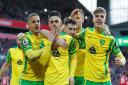 Milot Rashica and the Norwich players celebrate taking the lead at Anfield