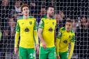 Norwich City players, from left, Josh Sargent, Grant Hanley and Max Aarons react to Southampton's first goal