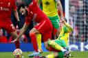 Brandon Williams snaps into a challenge on Mo Salah in Norwich City's 3-1 Premier League defeat at Liverpool