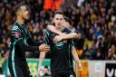 Canaries midfielder Kenny McLean celebrates his goal at Wolves with Billy Gilmour and Adam Idah, left