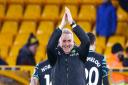 Dean Smith salutes the travelling support after Norwich City's 1-0 FA Cup fourth round win at Wolves
