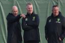 Norwich City head coach Dean Smith watches training at Colney alongside head of football development Steve Weaver, left, and assistant coach Craig Shakespeare, right