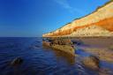 The wreck of the trawler Sheraton under the shadow of the striped cliffs at Hunstanton.