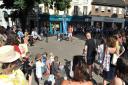A previous year of Head Out, Not Home in Norwich, with audiences watching performer William Sanchez in London Street.