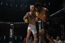Scott Butters lands punches on Kingsley Crawford in their fight at Cage Warriors 111. Picture: BRETT KING