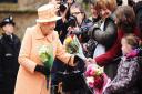 HM the Queen was presented with flowers by well wishers after morning service at Wolferton Church. Picture: Ian Burt