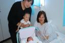 Newmarket couple Zhi Wei Zheng and Darlene Suttle with their new arrival and their 18-month-old daughter Zhia. Picture: QEH