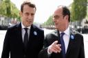 French President-elect Emmanuel Macron, left, and outgoing President Francois Hollande talk during a ceremony to mark the end of World War II at the Arc de Triomphe in Paris, Monday, May 8, 2017. France's youngest president faces the daunting task of reun