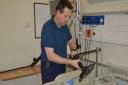 Mark Fowler, Norfolk and Norwich University Hospital senior medical equipment technician with one of the articulated arms. Pic: Norfolk and Norwich University Hospital.
