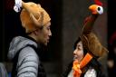 Tamari Hedani, right, and her boyfriend, Chris Chu, both from San Francisco, wear turkey hats prior to the start of the Macy's Thanksgiving Day Parade, Thursday, Nov. 27, 2014, in New York.  Photo: AP/Julio Cortez