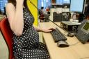 File photo of a pregnant office worker.  Anthony Devlin/PA Wire