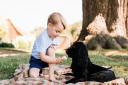 Prince George pictured with the family dog Lupo in the grounds of Amner Hall in Norfolk Matt Porteous/PA Wire