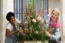 The Fun with Flowers festival being set up at St Peter's Church at Ringland. Jacqueline Kirkpatrick, left, and Kirstie Burton at work at the font on the display called Summer Blessings. Picture: DENISE BRADLEY