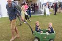 The Royal Norfolk Show 2016. Meals on wheels as 21-month-old twins Lyall, left, and Willis Dobson enjoy their wagon ride pulled by Marc Dobson. Picture: DENISE BRADLEY