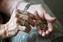 File photo dated 3/4/16 of an elderly woman counting loose change as plans to clamp down on early exit charges for people using new pension freedoms have been set out. PRESS ASSOCIATION Photo. Issue date: Thursday May 26, 2016. The Financial Conduct Autho
