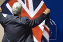 A member of protocol arranges the British flag prior to the arrival of British Prime Minister David Cameron at the European Parliament in Brussels. (AP Photo/Virginia Mayo)