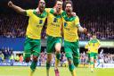 Norwich City's Jonathan Howson (centre) celebrates scoring the opening goal with team mates Cameron Jerome (left) and Bradley Johnson (right) during the Sky Bet Championship, Play Off Semi Final, First Leg at Portman Road, Ipswich. Photo: PA