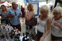 Wine-tasters gather around the Broadland Wineries stall at the Norfolk Show