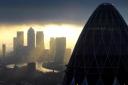 The 'Gherkin' and Canary Wharf. Photo credit should read: Stefan Rousseau/PA Wire