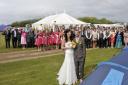 Newlyweds Kate Parnell and Neil Missen with their guests, and tents at their reception venue, the Woodhill Holiday Park at East Runton