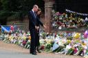 The Prince and Princess of Wales view flowers and tributes left at the Norwich gates at Sandringham in honour of the late Queen Elizabeth II