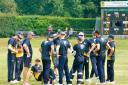 Norfolk players get a quick pep talk from coach Chris Brown as they take drinks at the halfway stage of the Shropshire innings.
