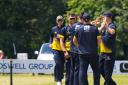 Norfolk players congratulate Ryan Findlay after a brilliant caught and bowled against Suffolk