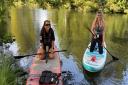 Oana Indries, 25, and Lottie  Ryan, 22, paddleboarding along the River Wensum in Norwich