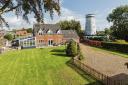 A four-bed property next to the historic Saham Mill is for sale