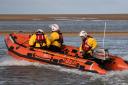 A woman and her dog were rescued after being cut off by the tide in Wells