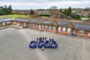 Staff and pupils at Dersingham Primary School celebrate their recent Ofsted report