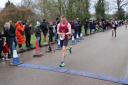 Mark Armstrong crosses the finish line at the Valentine's 10K