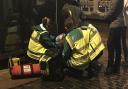 Norwich SOS Bus staff look after a woman on the floor outside of a bar