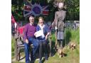 Maureen and Thomas Jarvis with their winning scarecrow, from a Platinum Jubilee-themed scarecrow contest in East and West Runton