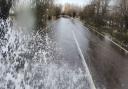 Photographer Terry Harris drives through the flooded A1101 at Welney.